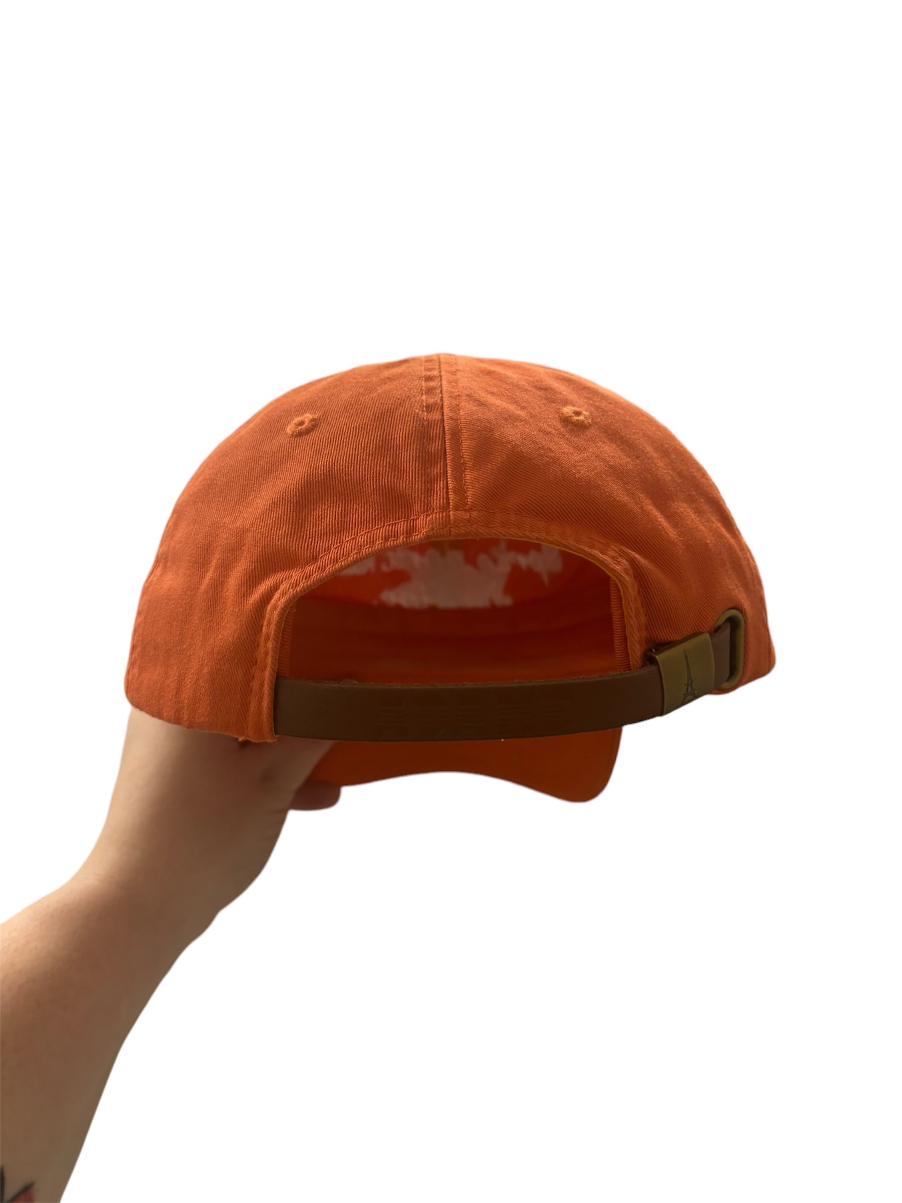 an orange baseball cap from behind