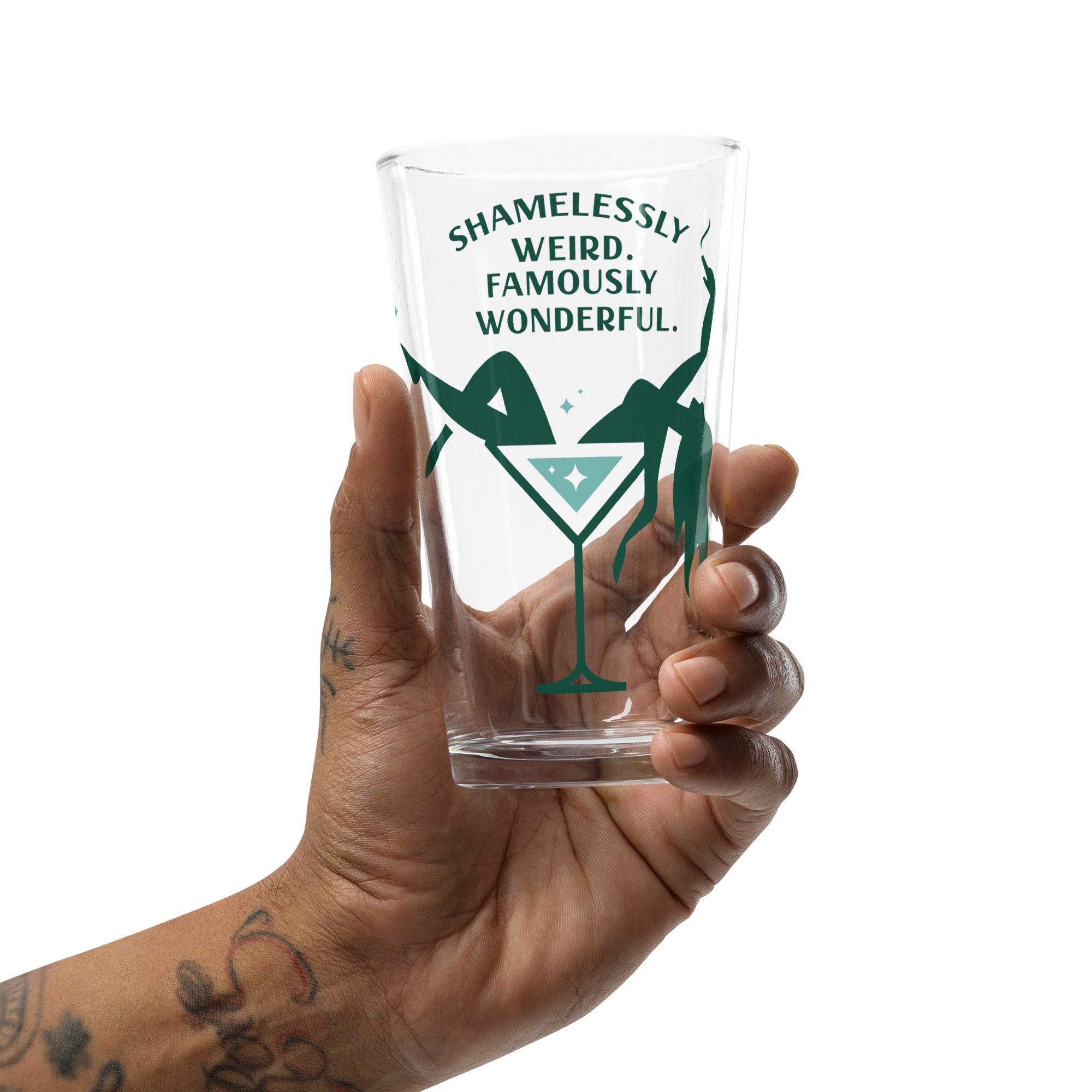 a pint glass with a green logo in someone's hand