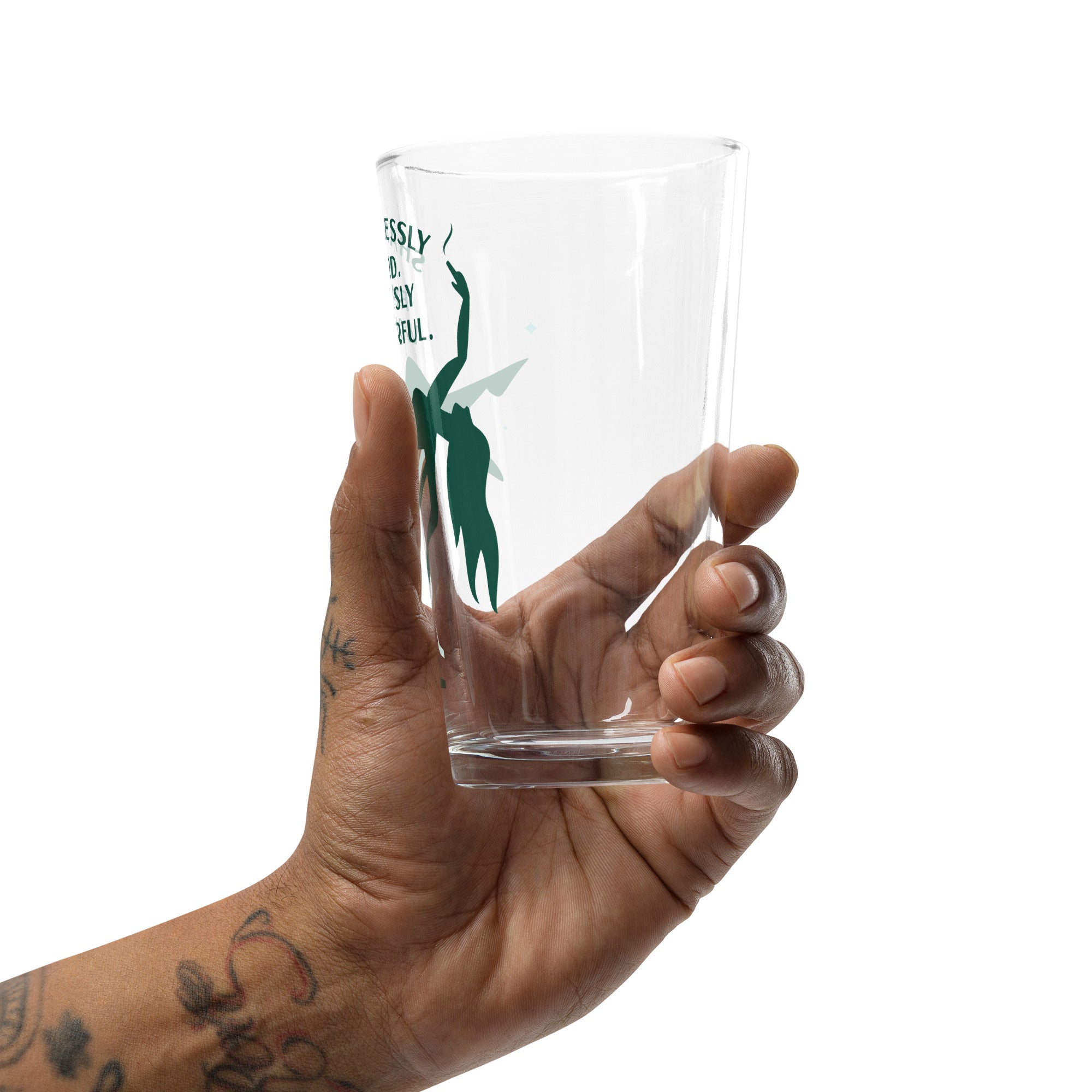 a pint glass with a green logo in someone's hand