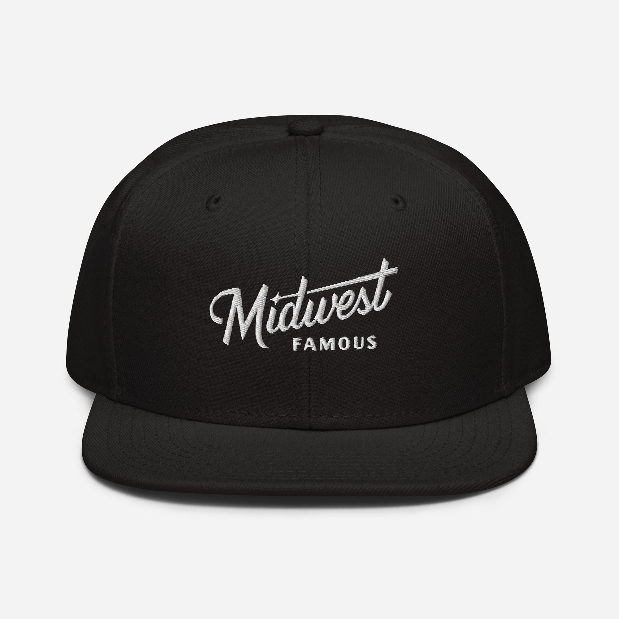 a black snap back hat with a white logo