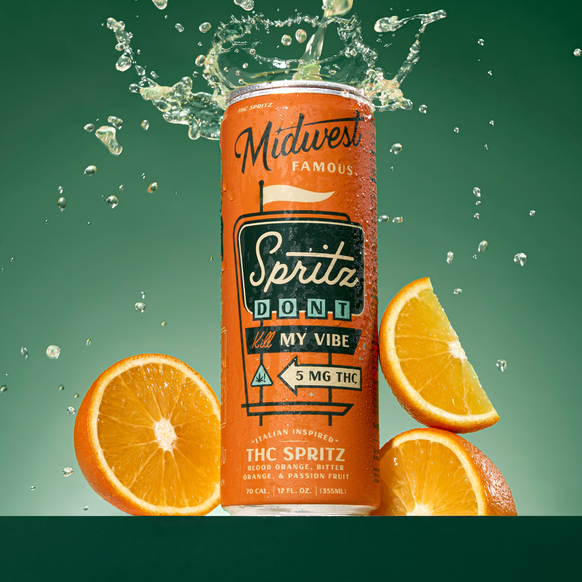An orange can spewing liquid with a green background and oranges in the foreground
