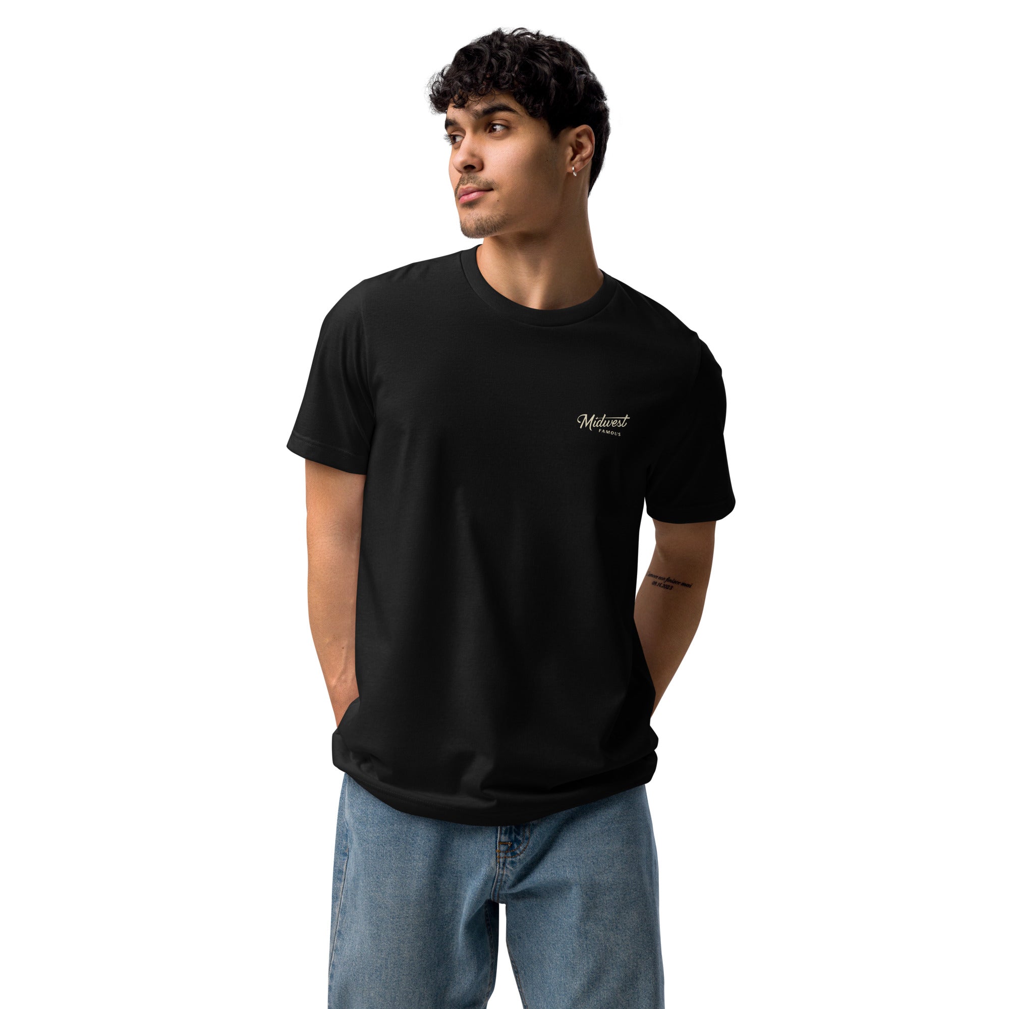a man standing front on wearing a black tshirt and jeans